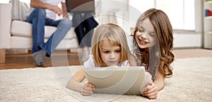 Happy little girls with tablet pc computer at home