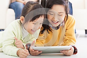 Happy little girls using tablet