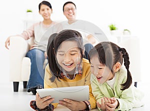 Happy little girls using tablet