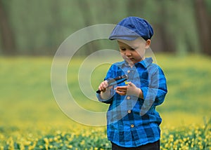 Happy little happy child boy, exploring nature with magnifying glass, summer. Concept of kid and nature