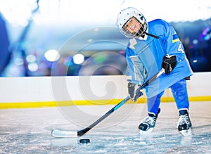 Happy little hockey player passing the puck