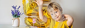 Happy little kid boy celebrating his birthday and blowing candles on homemade baked cake, indoor. Birthday party for