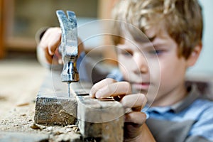 Happy little kid boy helping with toy tools on construction site. Funny child of 7 years having fun on building new