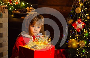 Happy little kid with Christmas light box. Winter kid. Winter delivery service for kids. Happy child with Christmas gift