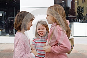 Happy little kid girls on the street in the city