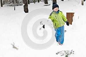 Happy Little Kid is Playing in Snow