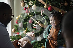 Happy little kid receiving a Christmas present