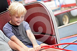 Happy Little Kid Riding Tilt-a-whirl Carnvial Ride