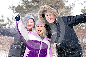 Happy Little Kids Playing Outside in the Winter Snow photo