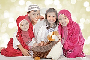 Happy little Muslim kids playing with sheep toy - celebrating Eid ul Adha - Happy Sacrifice Feast photo