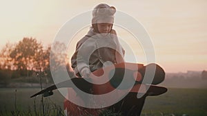 Happy little pilot boy gets in fun cardboard plane, gets up on sunset autumn field playing and having fun slow motion.