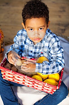Happy little preschool boy with basket of fresh lemons