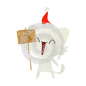 happy little retro cartoon of a dog holding sign wearing santa hat