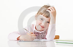 Happy little school girl learning to write