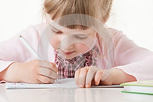 Happy little school girl learning to write