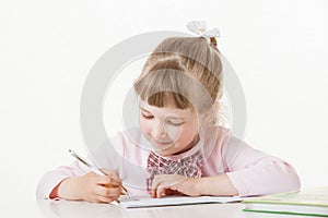 Happy little school girl learning to write
