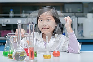 Happy little scientist making experiment
