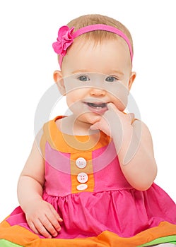 Happy little sly baby girl in bright multicolored festive dress photo