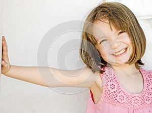 Happy little smiling girl leaning