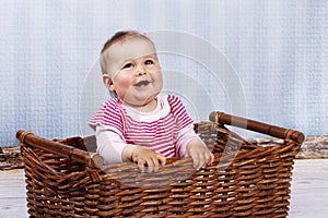 Happy little toddler laughing in the basket