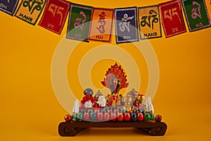 Happy Losar, Tibetan New Year background. Text on flags Om mani padme hum meaning The jewel is in the lotus