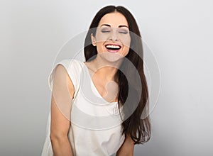 Happy loudly laughing woman with happy smile on blue background photo