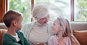 Happy, love and children hugging grandmother on a sofa in the living room at modern home. Smile, bonding and young kids