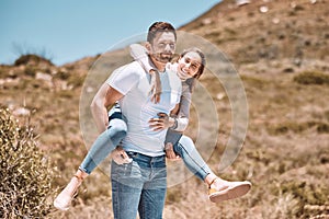 Happy and in love couple having fun in nature and enjoying quality time together. Cute and relax boyfriend piggyback or