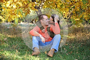 Happy love couple resting in forest and embracing, young family portrait, casual wear