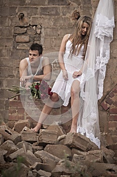 Happy in love couple standing together in old broken down building