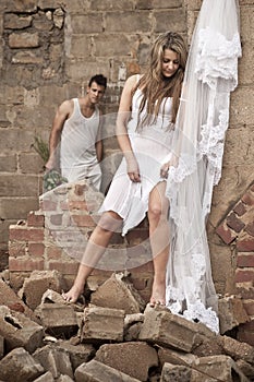 Happy in love couple standing together in old broken down building