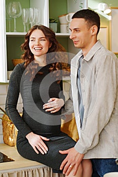 happy and in love man and pregnant woman in black dress.