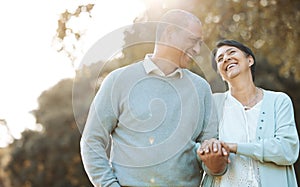 Happy, love and senior couple in a park on an outdoor date for romance, bonding or love. Smile, talking and elderly man