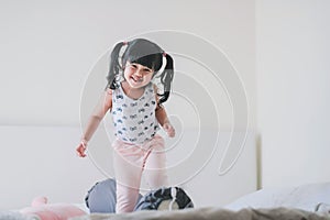 Happy Lovely Kids Portrait. A Three Years old Girl in Happiness Moment in Bedroom