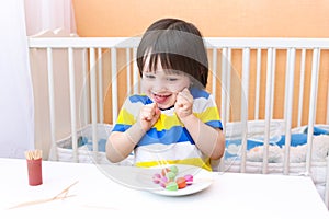 Happy lovely little boy with lollipops of playdough and toothpicks