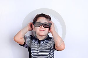 Happy lovely smiling boy in sunglasses, studio shoot on white. C