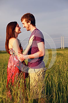 Happy lovers in field