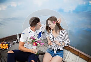 Happy lovers relaxing in boat on a lake