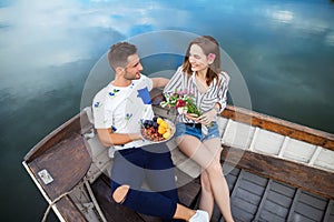 Happy lovers relaxing in boat on a lake