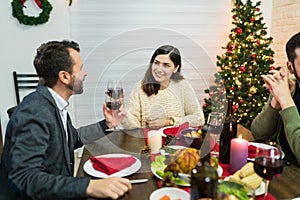 Happy Lovers Toasting Drinks At Home In Christmas