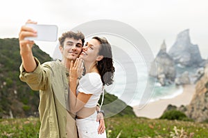 Happy loving couple embracing and taking selfie after engagement, capturing moment on photo