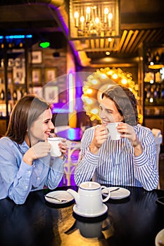 Happy loving couple enjoying breakfast in a cafe. Love, dating, food, lifestyle