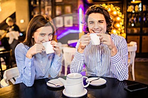 Happy loving couple enjoying breakfast in a cafe. Love, dating, food, lifestyle