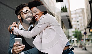 Happy loving couple. Happy young man and woman having fun together in city