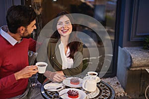 Happy loving couple having date at outdoor cafe