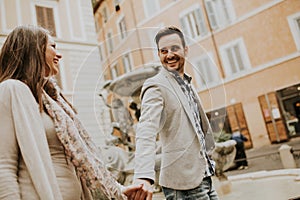 Happy loving couple, man and woman traveling on holiday in Rome, Italy