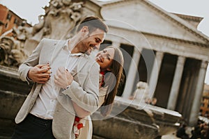Happy loving couple, man and woman traveling on holidays in Rome