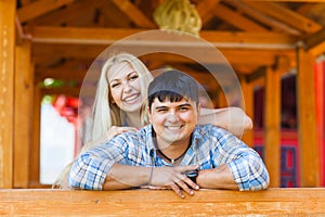 Happy loving couple. Portrait of beautiful young couple bonding to each other and smiling while both standing outdoors