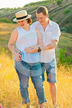 Happy loving couple at summer sunset.