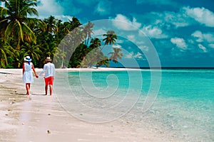 Happy loving couple walk on beach, vacation concept